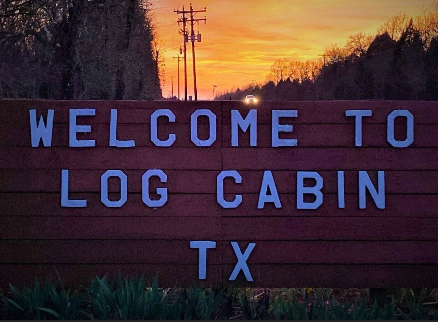 Welcome to Log Cabin TX sign at sunset